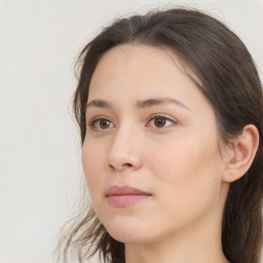 Neutral white young-adult female with long  brown hair and brown eyes