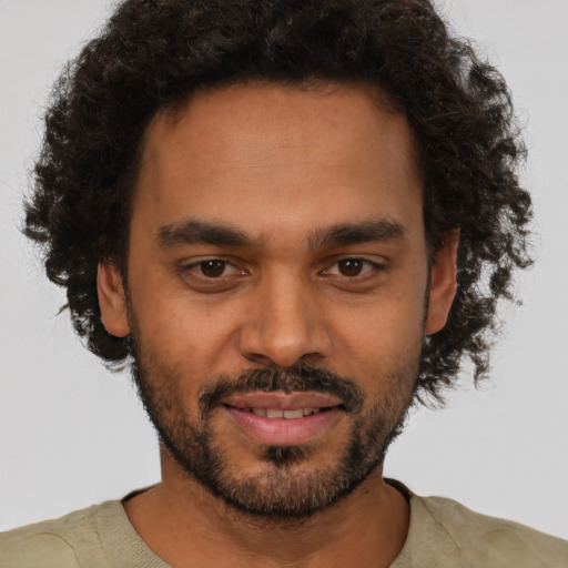 Joyful black young-adult male with short  brown hair and brown eyes