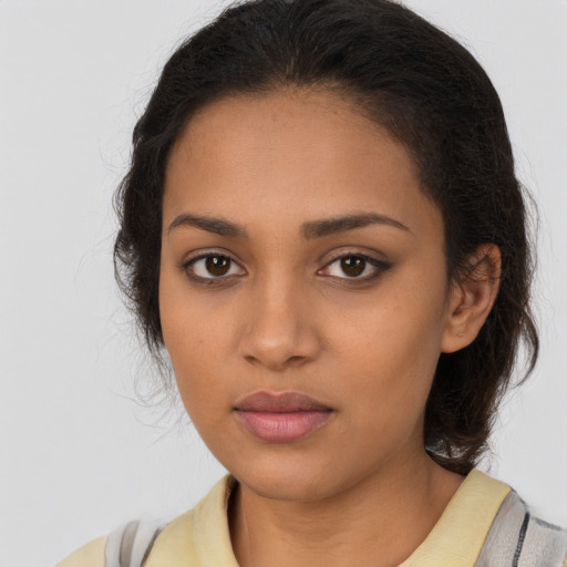 Joyful latino young-adult female with long  brown hair and brown eyes