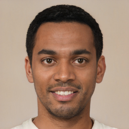 Joyful latino young-adult male with short  black hair and brown eyes