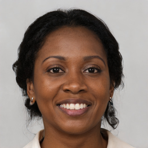 Joyful black young-adult female with medium  brown hair and brown eyes