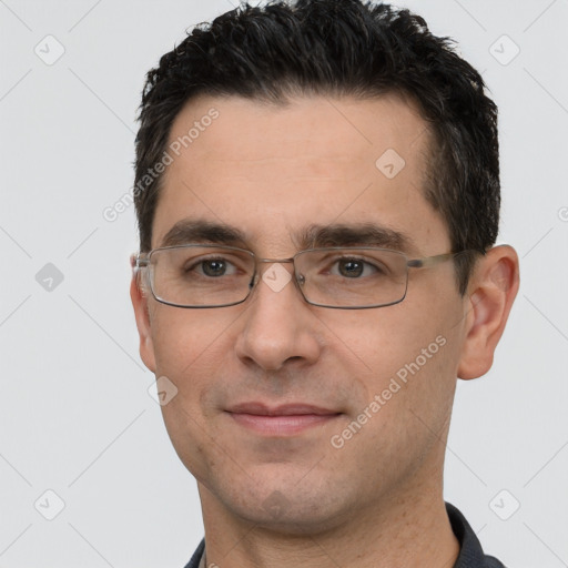 Joyful white young-adult male with short  black hair and brown eyes