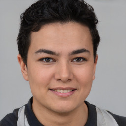 Joyful latino young-adult male with short  brown hair and brown eyes