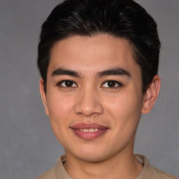 Joyful asian young-adult male with short  brown hair and brown eyes