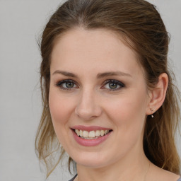 Joyful white young-adult female with medium  brown hair and green eyes