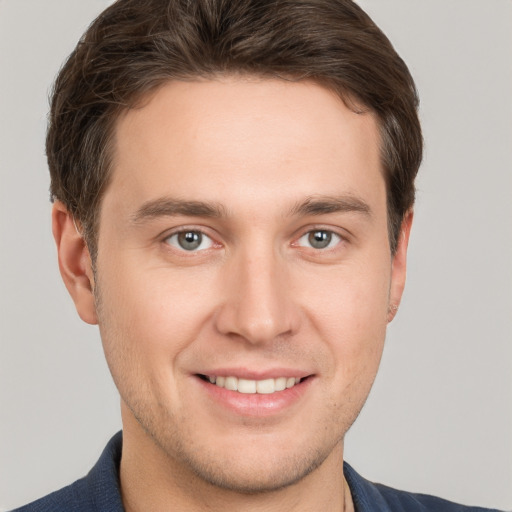 Joyful white young-adult male with short  brown hair and grey eyes