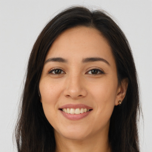 Joyful latino young-adult female with long  brown hair and brown eyes