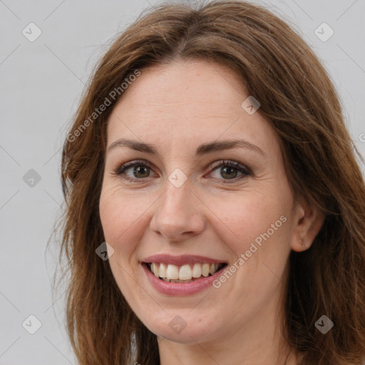 Joyful white adult female with long  brown hair and brown eyes