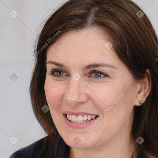 Joyful white adult female with medium  brown hair and brown eyes