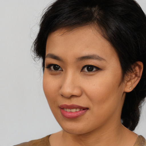 Joyful asian young-adult female with medium  brown hair and brown eyes