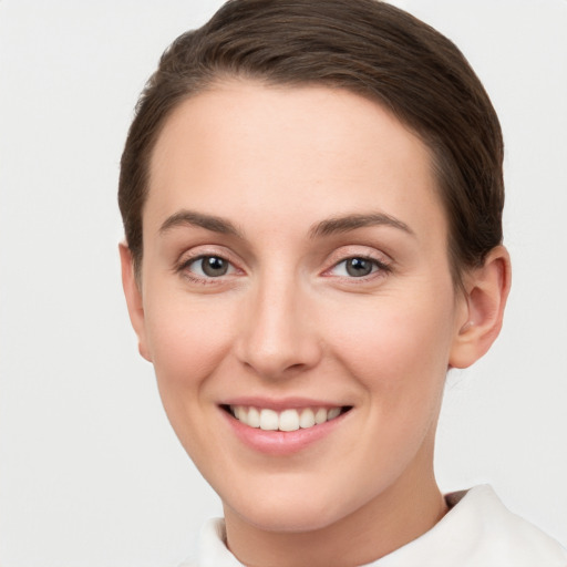 Joyful white young-adult female with short  brown hair and brown eyes