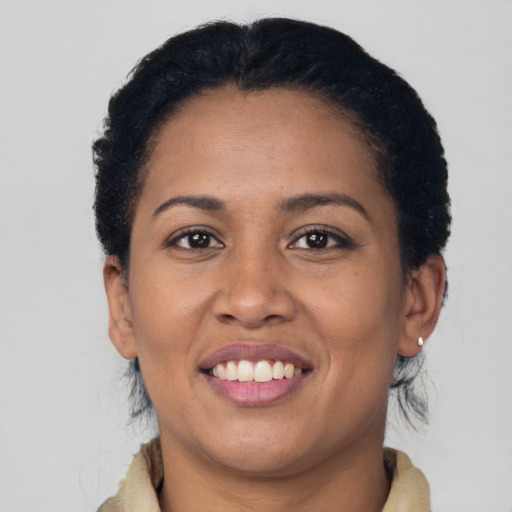 Joyful latino young-adult female with medium  brown hair and brown eyes
