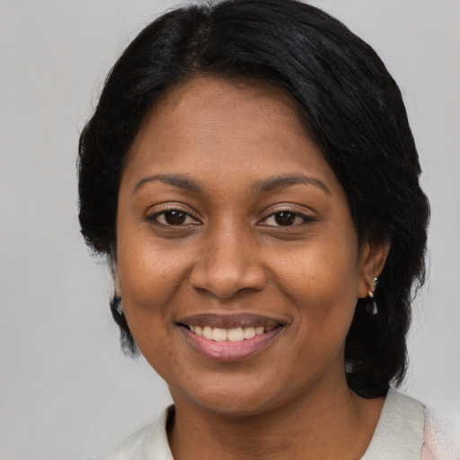 Joyful asian adult female with medium  black hair and brown eyes