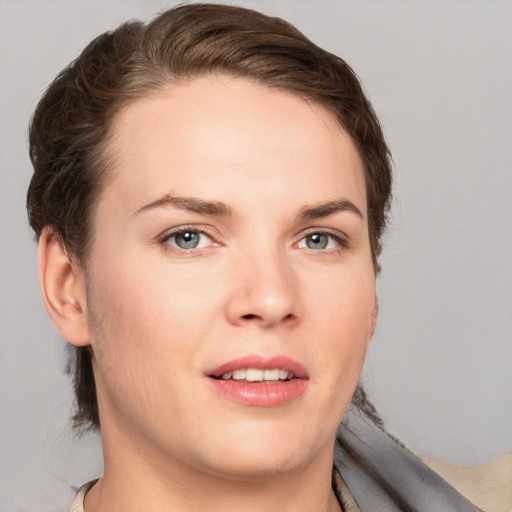 Joyful white young-adult female with short  brown hair and grey eyes