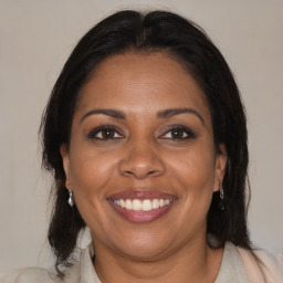 Joyful black adult female with medium  brown hair and brown eyes