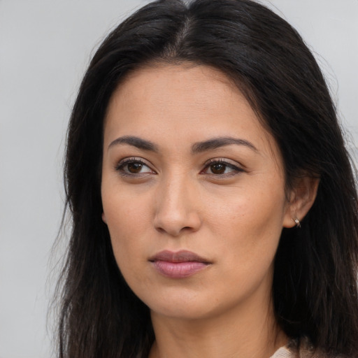 Joyful asian young-adult female with long  brown hair and brown eyes