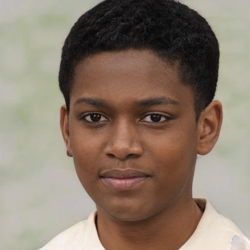 Joyful black child male with short  black hair and brown eyes