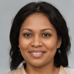 Joyful black adult female with medium  brown hair and brown eyes