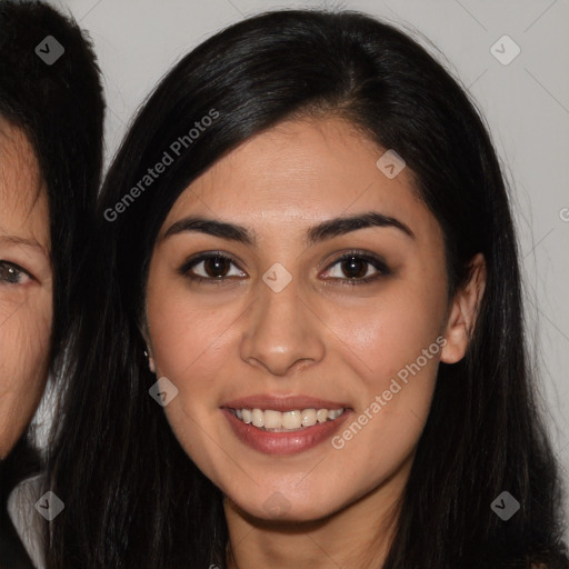 Joyful latino young-adult female with long  brown hair and brown eyes