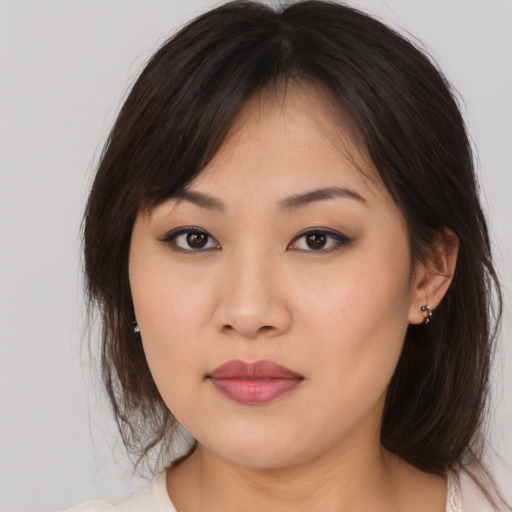 Joyful asian young-adult female with medium  brown hair and brown eyes