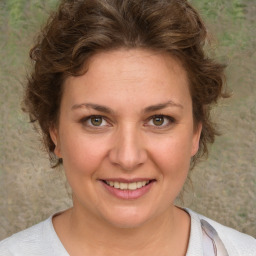 Joyful white young-adult female with medium  brown hair and blue eyes