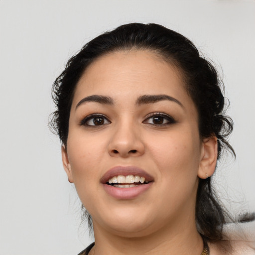 Joyful latino young-adult female with medium  black hair and brown eyes