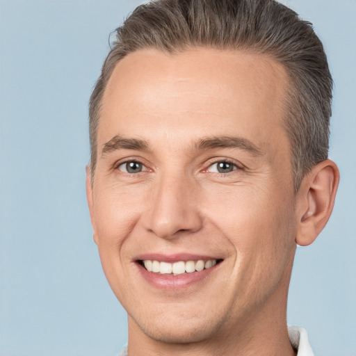 Joyful white adult male with short  brown hair and brown eyes