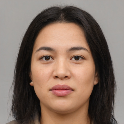 Joyful asian young-adult female with long  brown hair and brown eyes