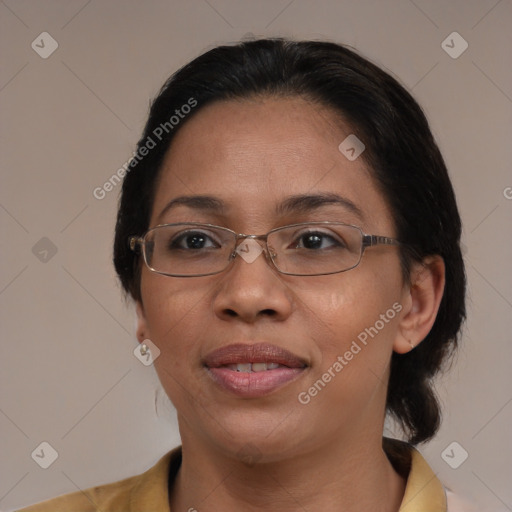 Joyful black adult female with medium  brown hair and brown eyes