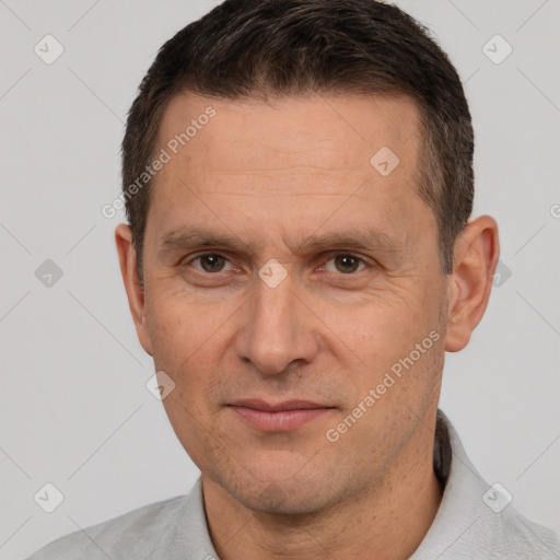 Joyful white adult male with short  brown hair and brown eyes