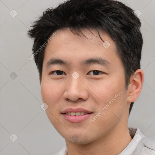 Joyful asian young-adult male with short  brown hair and brown eyes