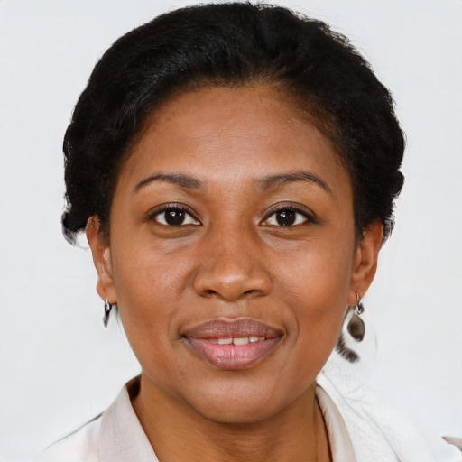 Joyful black adult female with short  brown hair and brown eyes