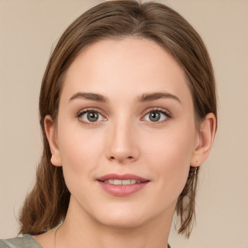 Joyful white young-adult female with medium  brown hair and green eyes