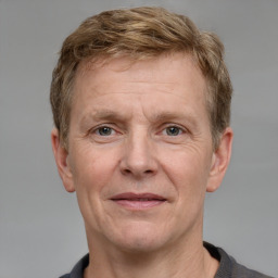 Joyful white adult male with short  brown hair and grey eyes