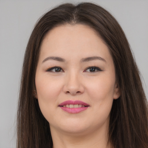 Joyful asian young-adult female with long  brown hair and brown eyes