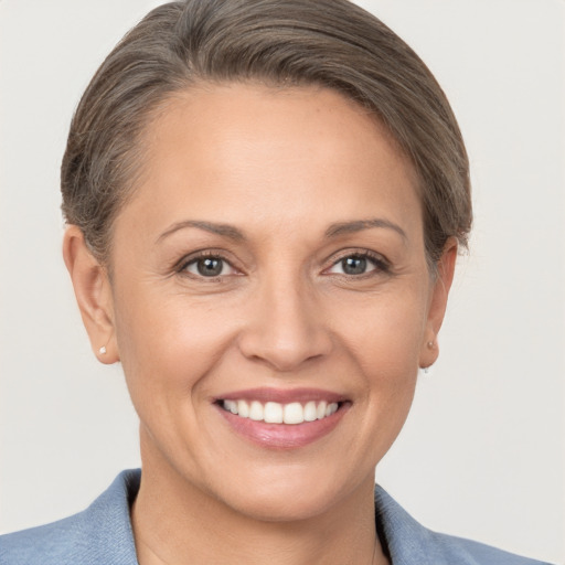 Joyful white adult female with short  brown hair and brown eyes