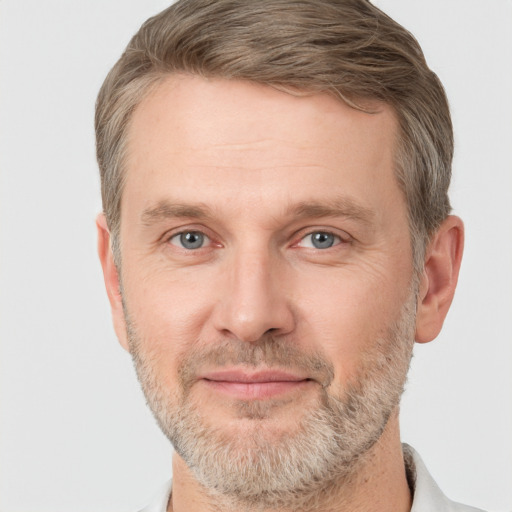 Joyful white adult male with short  brown hair and grey eyes