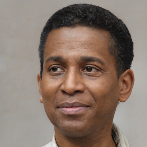 Joyful latino adult male with short  black hair and brown eyes