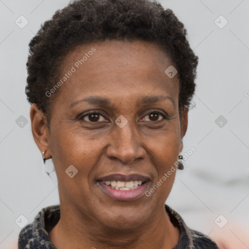 Joyful black adult female with short  brown hair and brown eyes