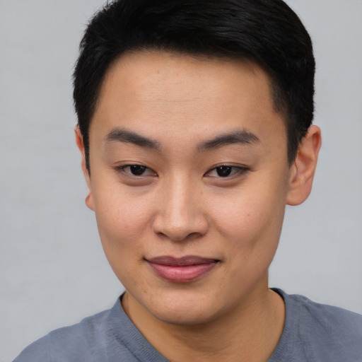 Joyful asian young-adult female with short  black hair and brown eyes