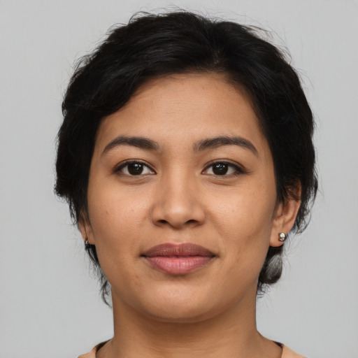 Joyful asian young-adult female with medium  brown hair and brown eyes