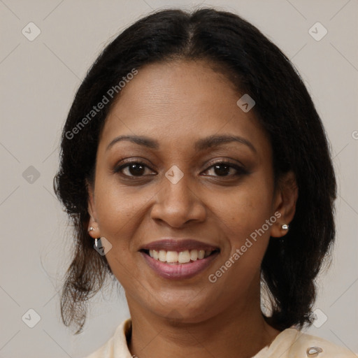 Joyful black adult female with medium  brown hair and brown eyes