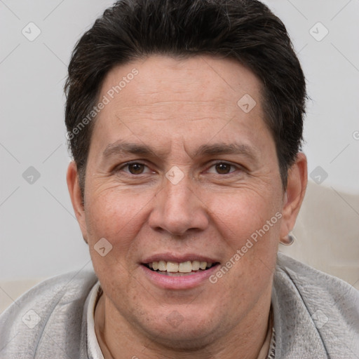 Joyful white adult male with short  brown hair and brown eyes