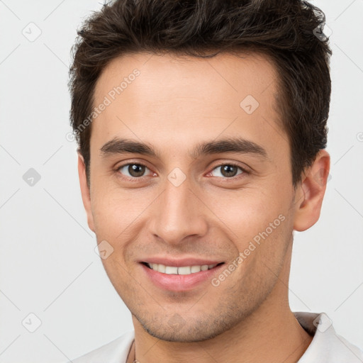 Joyful white young-adult male with short  brown hair and brown eyes