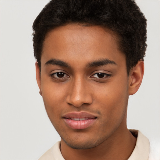 Joyful latino young-adult male with short  brown hair and brown eyes