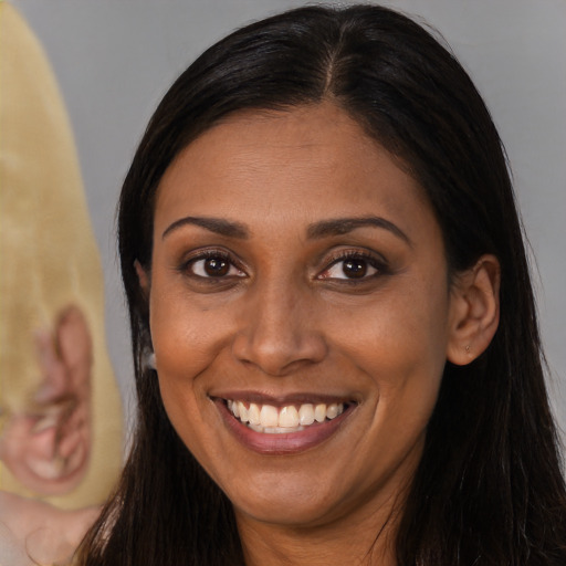 Joyful latino young-adult female with long  brown hair and brown eyes