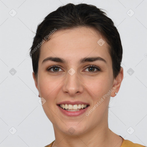 Joyful white young-adult female with short  brown hair and brown eyes