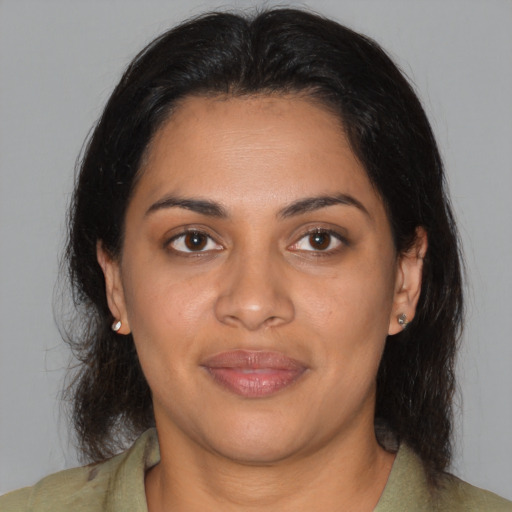 Joyful latino young-adult female with medium  brown hair and brown eyes