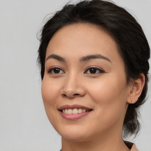 Joyful asian young-adult female with medium  brown hair and brown eyes