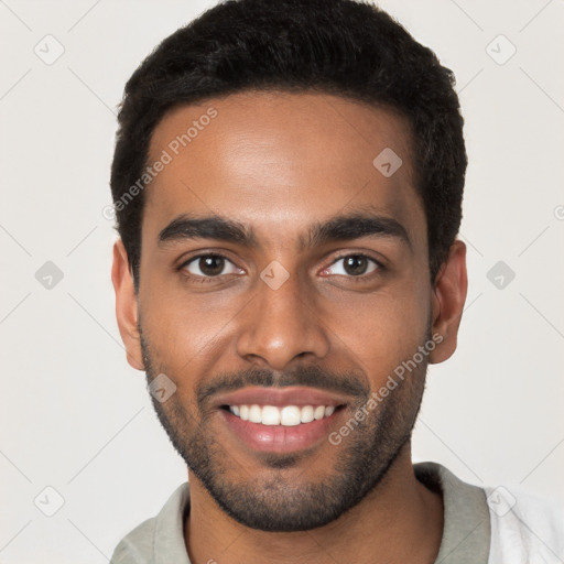 Joyful black young-adult male with short  black hair and brown eyes